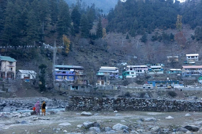 Keran/LoC/Kupwara district/2023.
Two women living in the areas that come under the authority of Indian Government going to take a bath in Jhelum River which is considered as LoC, a de facto border since independence. Houses and other people seen in the photograph are belongs to the area under control of Pakistan.