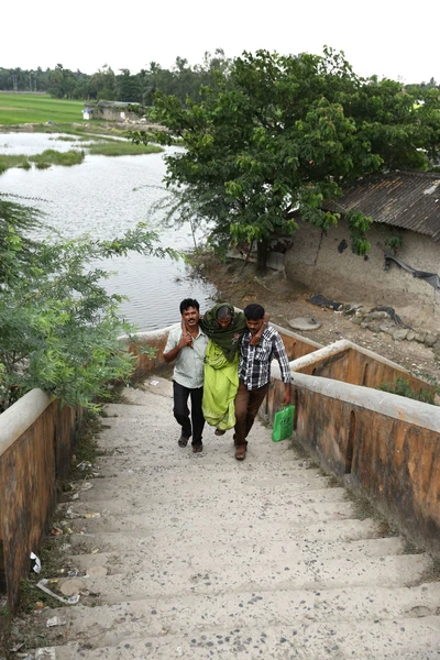 On shoulders of children. Mother being taken to hospital. Take from Canning, Bengal. 