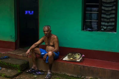 Moideen has no clue about his year of birth, thus the whole story lies somewhere in a vagueness. When he was past 25, Moideen and his friend Azeez moved from their native town Kozhikode, Kerala, to Mangalore city , Karnataka in search of jobs. The last marriage happened 30 years ago and another 10-15 years go back when he recalls his first visit to Mangalore. Three of their children are married and settled in different places. Moideen no longer works , after he met with a motorcycle accident last year. Subaida makes beedi in her free time and earns 160 rupees for 1000 beedis.
Taken from Abira, Kaniyoor, Karnataka.