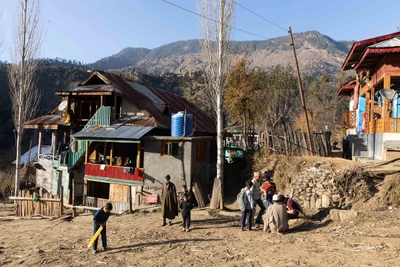 Army person notes down children's details. Keran/LoC/Kupwara district/2023