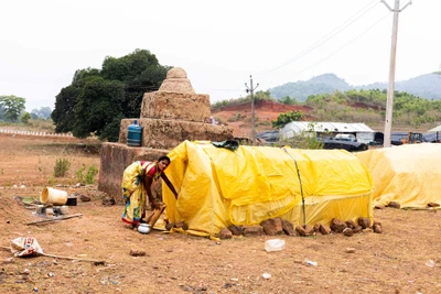 A woman who reached here with family as a worker of water authority, maintaining a makeshift hut. The sthoopa that visible in the back ground is a martyrdom, built by Naxalites.   Garram village, Chitrakonda, Malkangiri/2023