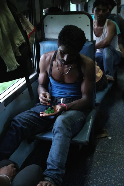 A migrant worker going home from Kerala. He is in a second class coach 