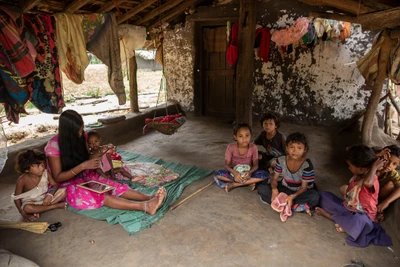 A woman who recently became a mother takes the responsibility of looking after other kids of the village while the rest of the villagers are at work in the paddy fields. 
Chinthagupha village is 30 kilometers away from Dornapal. Sukma district. Chhattisgarh.