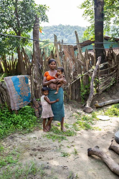 Gangi Sodi with her elder daughter Nande and her baby, who is yet to be named.
Bhima Mandvi, Gangi's husband is a farmer and owns few cows as well.

Taken from Maroki village. 
Gadiras tehsil, Sukma District