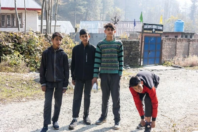 Boys going to school after collecting milk from the adjacent Army camp. Babagail village, Limber wildlife sanctuary,LoC, Baramulla/2023