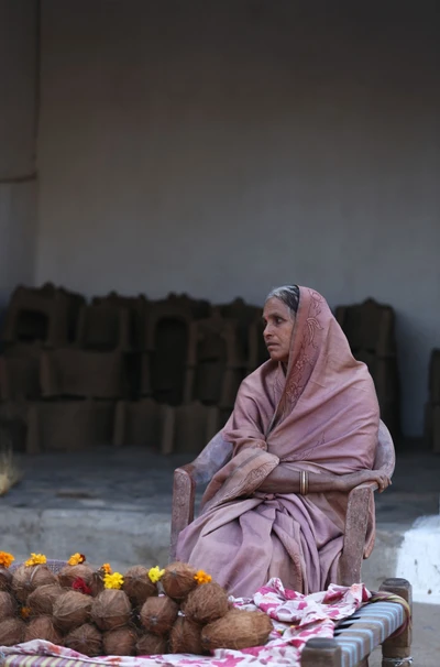 Sirpur is a famous place for its archaeological monuments and temples. A woman selling coconut for the devotees. 
