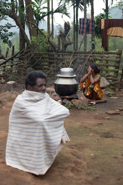 Kaalimoopan chieftain of Edavani Hamlet. One sitting near by the fire wood is Panali. 2015  