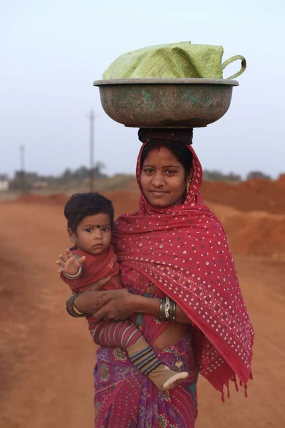 After daily wage work, an woman going back with her child. Some how she manage to keep son with her all the day; sometimes letting him play alone, sometime making him sleep and sometimes watching him crying.
Take from a construction site near New Raipur