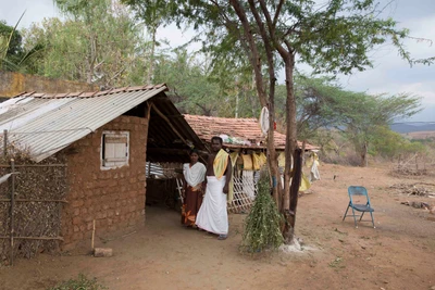 Murugan in front of his house with wife. 2017. His land is on a civil case as someone from Tamil Nadu claims ownerships. Murugan says its an attempt for snatching his land by forgery of documents. 