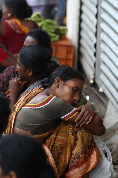 A woman gets a nap in Bagajatin station in Bengal on the way to home after work.