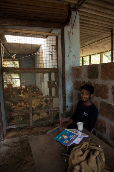  Jaison is a first-year mechanical engineering student in Moodabidri, a town 40 kms away from his house in Koyur, Belthangadi taluk. Since it is Diwali holidays, Jaison is in charge of his father's younger brother's chicken shop. The shop has a wood workshop running parallelly in an adjacent room, and that’s where he received the Diwali puja prasad. Jaison's father Furtado was born as the third son to a Konkani Christian couple, in Koyur village. Furtado got the proposal of Mary from Hubli, while working as a mechanic in Dharwad. They were married in 1989 and within two years, he returned to his native and started working as a building painter. He has 5 siblings; 2 brothers and 3 sisters. Jaison has a younger sister. The family visits Hubli once every year, a 360 km journey from here. Jaison’s childhood memory of his mom’s place is houses and shops situated much closer to each other, when compared to Koyur.