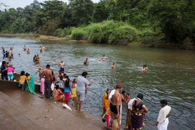 a father and daughter is all set for their holy dip (on right side)
