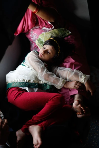 Take from a train, in Andra Pradesh. Taking rest on mother's lap as she got bored with her toys. 