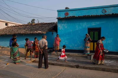 This is Mahipani village in Rourkela district of Odisha. Mahipani lies close to Jharkhand and that areas of Jharkand is noted for Maoist presence.
A diwali celebration was going on in the village, which was postponed for two weeks as some people in the village were ill.
The woman who is drawing is Leelavathi and Barsa is her daughter who is following her.