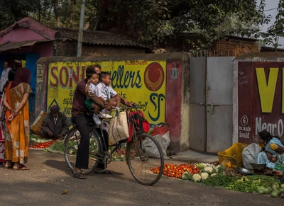 Biren and Barun are in the main seat of cycle and who runs the cycle is their father's elder brother, Sathia lal. Taken from Burla, near Hirakund Dam.